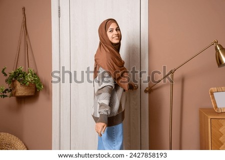 Image, Stock Photo Young arab woman opening a box with products while smiling, concept retail and buying online