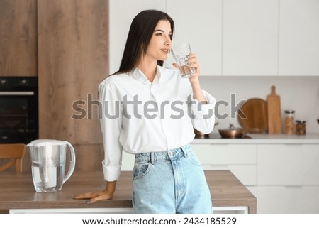 Image, Stock Photo Young woman drinking water while training on mat at home