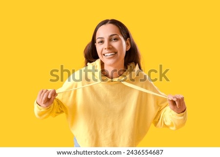 Image, Stock Photo Woman in yellow hoodie taking selfie on smartphone on rocky shore