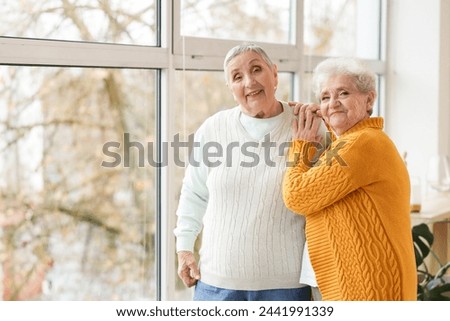 Similar – Image, Stock Photo Best female friends near lake during holiday