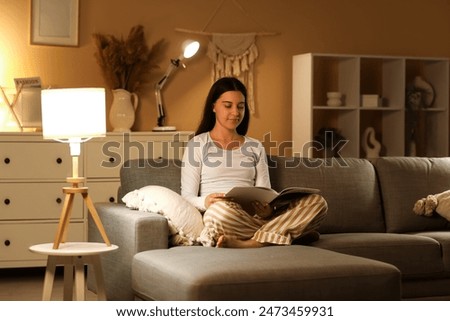 Similar – Image, Stock Photo A woman reads a book