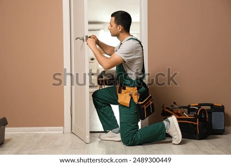 Similar – Image, Stock Photo young handyman installing wooden floor