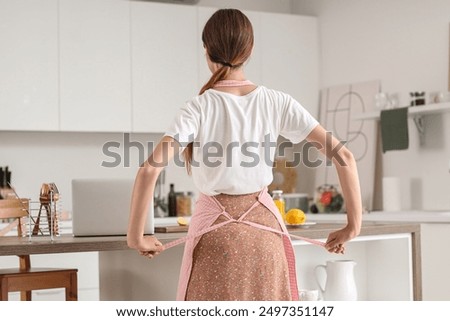 Similar – Image, Stock Photo Young Woman Tying Back Hair and Smiling in Bathroom