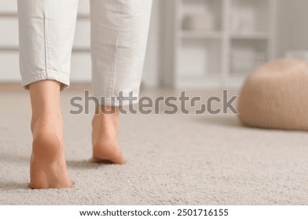 Similar – Image, Stock Photo Young female walking barefoot on wet sand