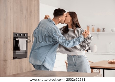 Similar – Image, Stock Photo Couple kissing in kitchen on counter