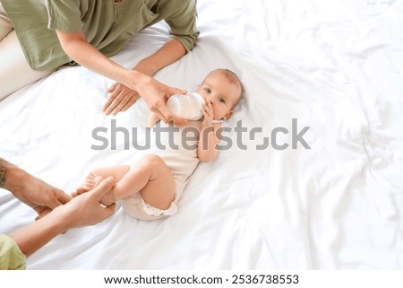 Similar – Image, Stock Photo Mother feeding baby at home