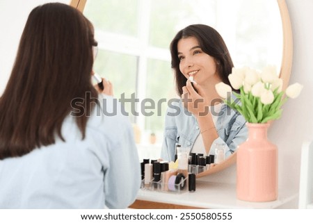 Similar – Image, Stock Photo Woman applying lipstick near car mirror