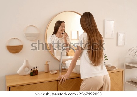 Similar – Image, Stock Photo Woman applying lipstick near car mirror