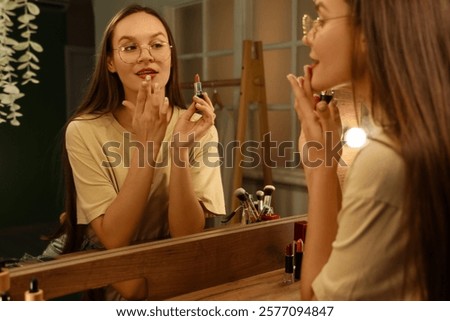 Similar – Image, Stock Photo Woman applying lipstick near car mirror