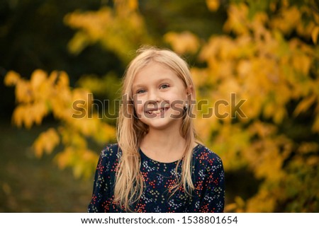 Similar – Image, Stock Photo Little girl, eight years old, sitting on the grass outdoors.