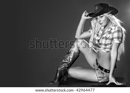 Monochrome portrait of a sexy woman in cowboy hat