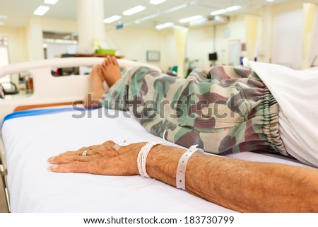 elderly patient lie down on bed in emergency room in rural hospital ,Thailand