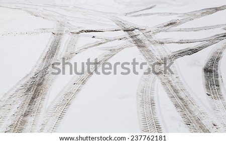 Snowy winter crossroad with tire tracks in snow
