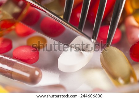 food pills, knife and fork