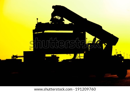 Silhouette of port warehouse with container cargo and forklift