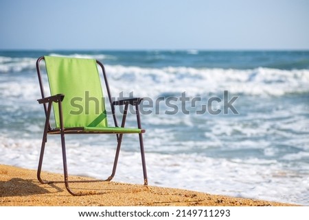 green folding chair on the sea beach. Summer vacation concept Foto stock © 