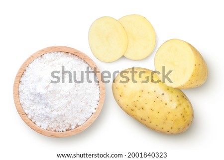 Potato starch (ground potato) in wooden bowl and fresh potatoes with slice isolated on white background. Top view. Flat lay.