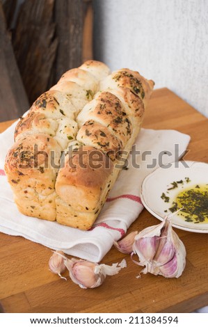 A loaf of garlic bread with olive oil and