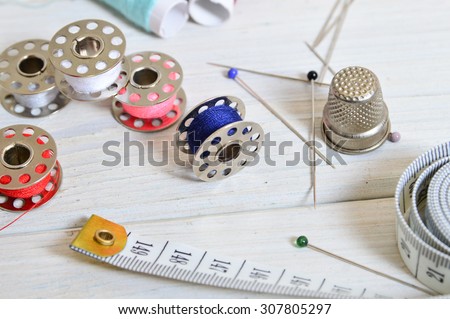 sewing tools and colored tape/Sewing kit. Scissors, bobbins with thread and needles
