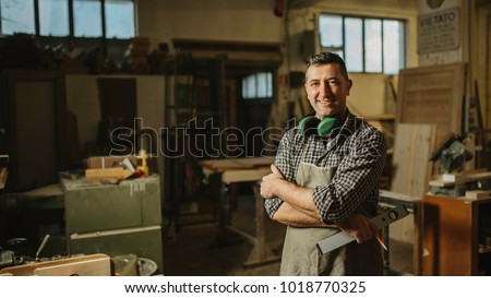 Similar – Image, Stock Photo Repairman with headphones in workshop