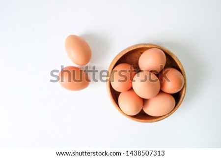 Similar – Image, Stock Photo Eggs in a bowl and baking ingredients on a kitchen table. Rustic.