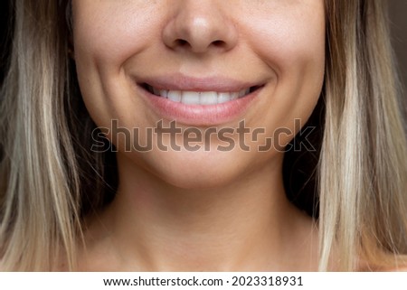 Similar – Image, Stock Photo Young dimpled woman smiles and looks at camera while standing in front of petrol blue wall