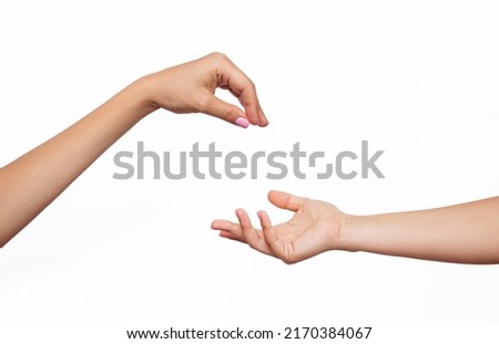 Female hand makes a gesture like handing some kind of hanging object as keys to the other outstretched hand isolated on a white background. Mockup with empty copy space for a intended object. Handover Foto stock © 