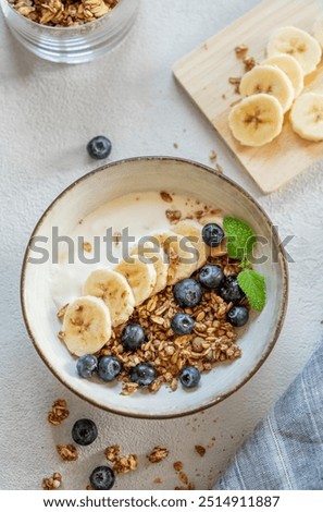 Similar – Image, Stock Photo A muesli with yoghurt and fresh fruit in a preserving jar on the breakfast table