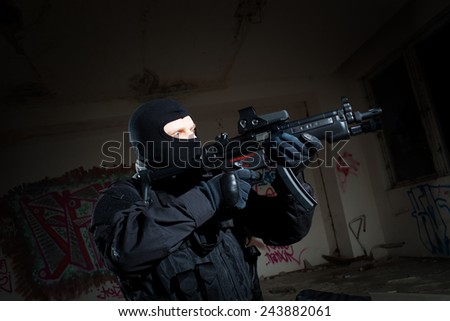 Special forces/ anti-terrorist police unit/private military contractor during night CQB hostage rescue raid/operation/mission (very harsh light for underline the atmosphere)