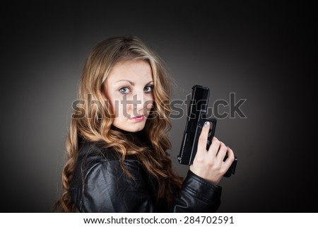 Top secret FBI female agent holding pistol (very harsh light for underline the atmosphere)