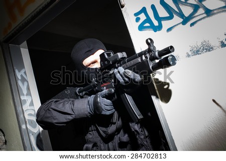 Special forces/ anti-terrorist police unit/private military contractor during night CQB hostage rescue raid/operation/mission (very harsh light for underline the atmosphere)