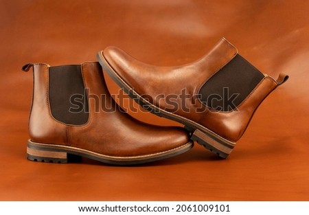A pair of tan brown Chelsea boots on a monochromatic matching background. ストックフォト © 