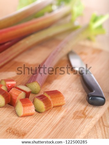 Close Up of  Red and Green Rhubarb Stalks Freshly Picked from a Farm Country Garden and Cut into Pieces for Baking a Pie, Crisp, Cobbler, Cake, or Jelly in Vertical Orientation