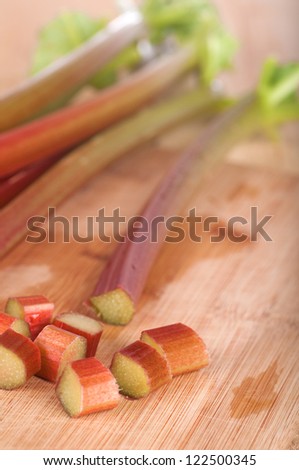 Close Up of  Red and Green Rhubarb Stalks Freshly Picked from a Farm Country Garden and Cut into Pieces for Baking a Pie, Crisp, Cobbler, Cake, or Jelly in Vertical Orientation