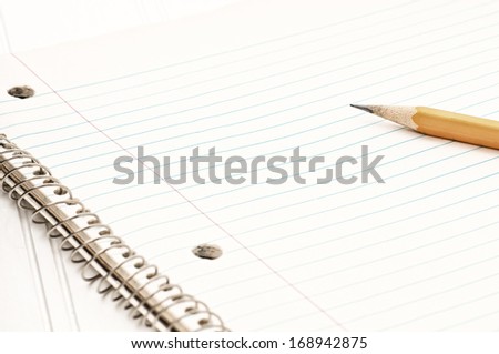 Closeup of an Old Notebook of Paper with a Pencil on the side.  Horizontal with room or space for your words, text or copy.  Modern look or treatment