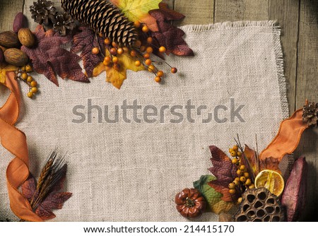 Fall Season card with Nature Elements in Rustic Setting with Burlap and old wood background from above with empty room or space for copy, text, your words, horizontal.  Vintage warm tones