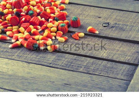 Halloween Candy Corn in Pile Spread on Rustic Textured and Weathered Wood Background with room or space for copy, text, your words.  Horizontal instagram