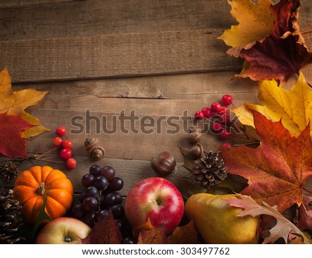 Peaceful Fall Fruit, Leaf, Acorn Still Life Arrangement on Rustic Wood Board Table Background with room or space for copy, text, your words.  Horizontal dark, warm,  vintage tone. Good as vertical
