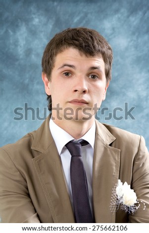 The man in brown suit on blue background