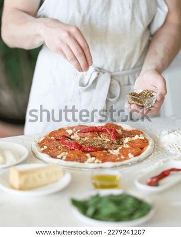 Similar – Image, Stock Photo Making pizza pepperoni with raw dough and ingredients