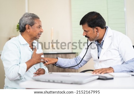 senior patient visitng doctor due to suffering chest pain at hospital - concept of health check up, illness or decease and medical treatment. Stock foto © 