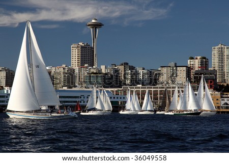 Sailboat sport race in ocean with space needle in Seattle Washington