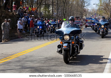 HOPKINTON, USA - APRIL 16: The Boston Marathon\'s starting line just after the beginning of the race with the Kenyans leading the competition in Hopkinton, Massachusetts, USA on April 16, 2012.