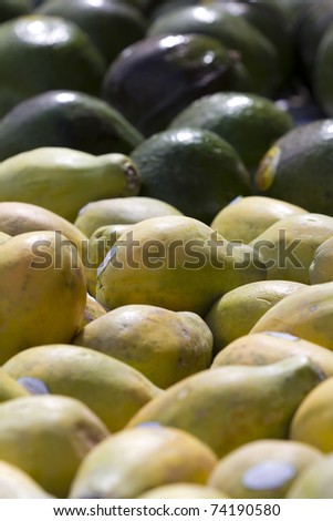 Papayas and Avocados on a Street Market\'s table.