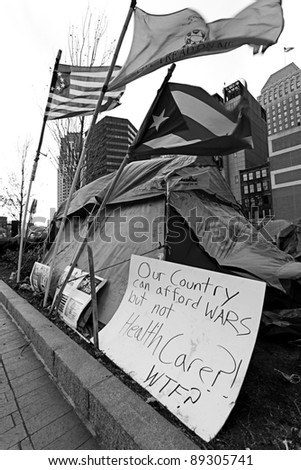 BOSTON, MASSACHUSETTS - NOVEMBER 19: Camp of the Occupy Boston with its signs, banners and flags of protest in Boston, Massachusetts, USA on November 19, 2011.