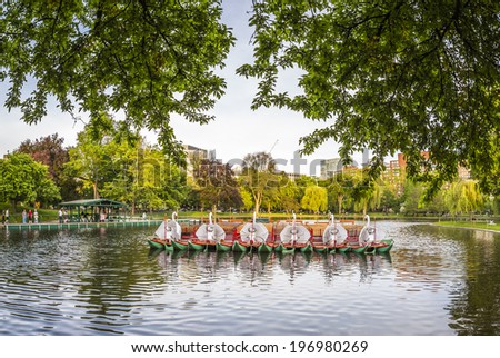 BOSTON, USA - JUNE 2: Panoramic view of the architecture of the Boston Public Garden in Boston, MA, USA with its famous swan pedal boats and some locals enjoying the nice weather on June 2, 2014.