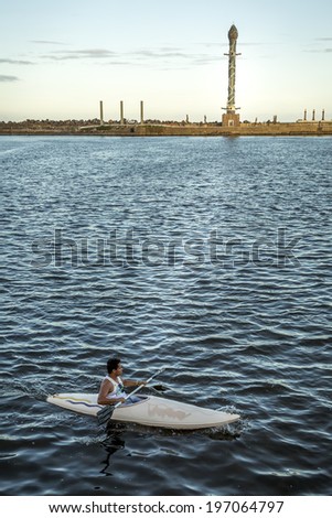 RECIFE, BRAZIL - APRIL 12: View of Marco Zero in Recife Antigo, PE, Brazil with its famous and controversial ceramic obelisk and locals passing by on a boat on April 12, 2014.