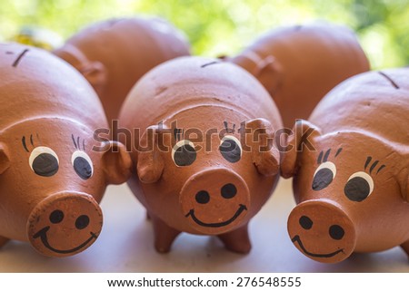 Close-up photo of some rustic piggy banks made of clay.