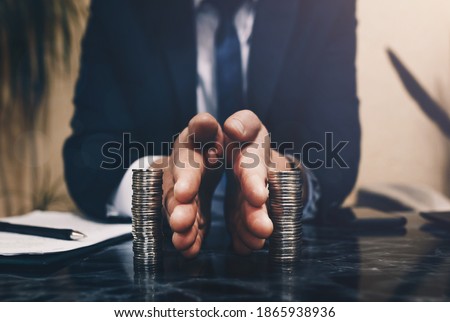 Businessman separates stack coins. Concept of  saving and investing.  Property division. Divorce and legal services.