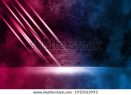 Rays neon light on neon brick wall with smoke. Neon reflections on wet asphalt. Empty scene with copy space.